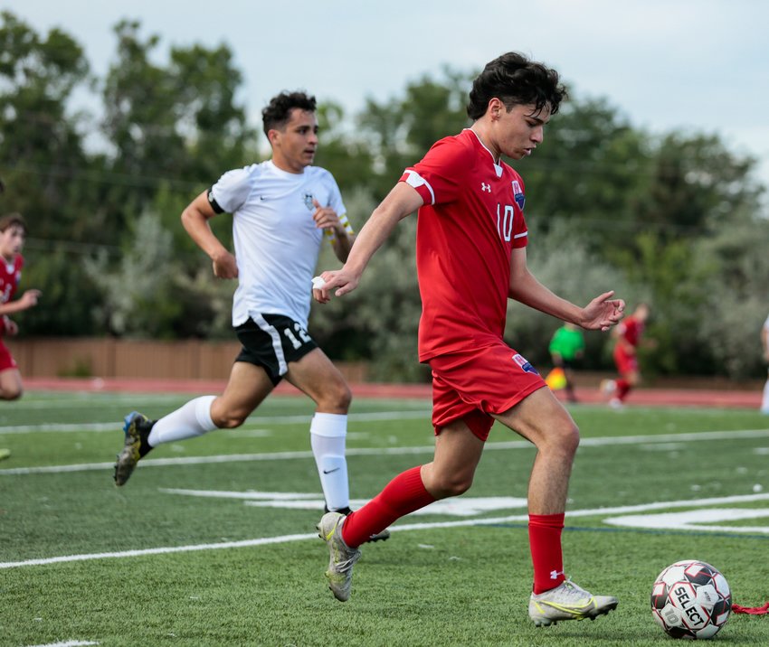 Heritage's Edison Jimenez has the ball and a small lead on a Highlands Ranch defender during the teams' Continental League match in Littleton Sept. 22.